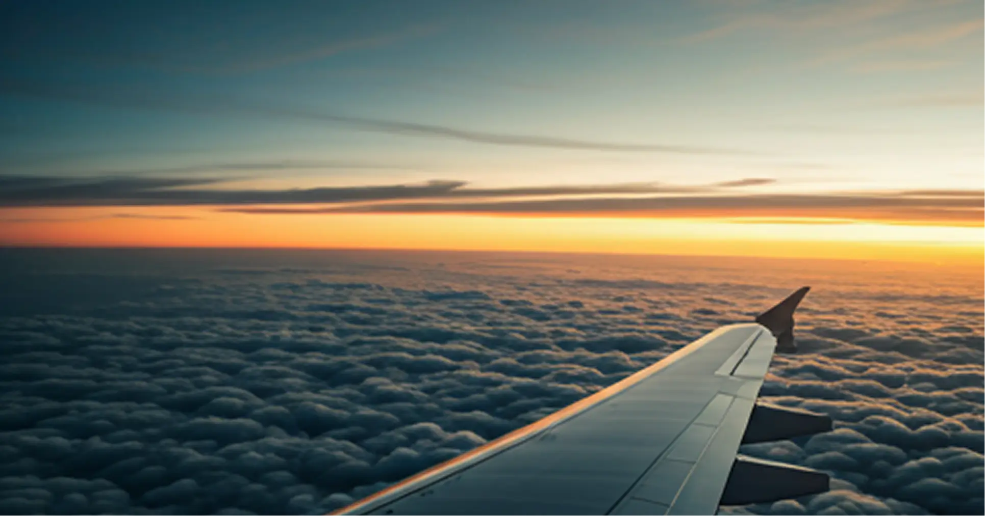 Airplane wing above clouds for quarterly overseas travel