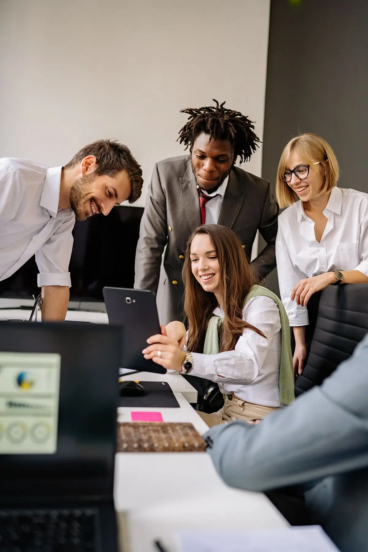 AVATOR team members collaborating around a laptop
